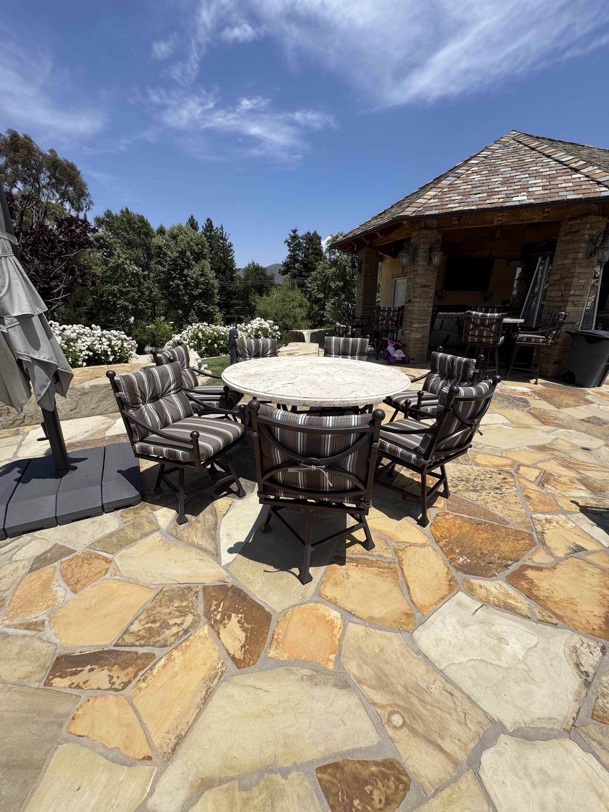 Estate patio dining set with custom striped cushions