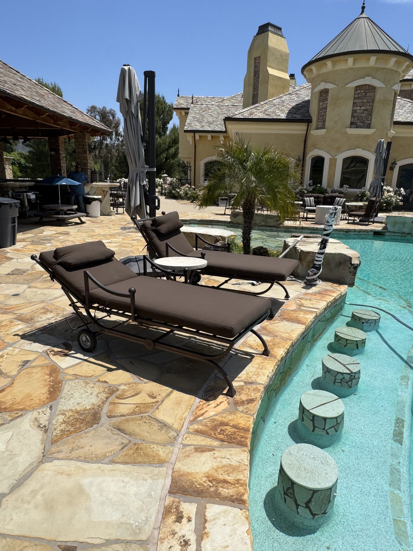 Poolside chaise loungers with brown cushions